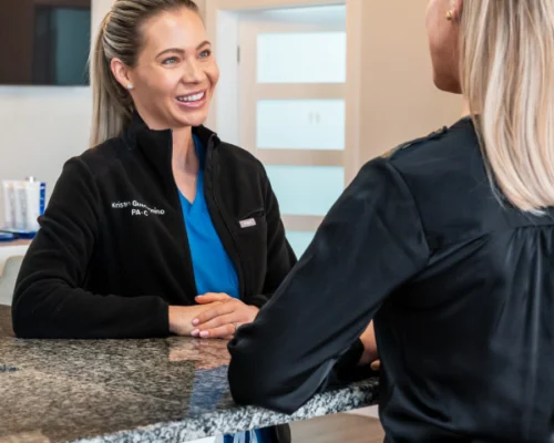 Relive Health Hendersonville Med Spa Lobby with female employee speaking with customer (2) 600x600
